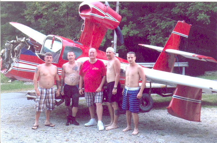 From left to right: Ricky Middleton, Travis Smith, Divers Den Owner Dean Littrell, Kevin Barnhouse, and Donald Maxfield are shown with a single-engine, two-seater plane equipped for water landings they pulled up after they were called to Cumberland Point to recover the aircraft from the depths of Lake Cumberland.