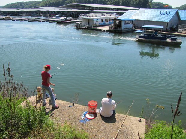 Karrie Bibb, left, and her husband Brent Bibb fish from the bank at Lake Cumberland State Dock on 5/24/2013 while their children Kayden, 2, and Jordan, 3, watch. The water level was much lower in the lake last summer. Bill Estep photo <br /><br />Read more here: http://www.kentucky.com/2014/01/29/3058693/endangered-fish-found-in-lake.html#storylink=cpy