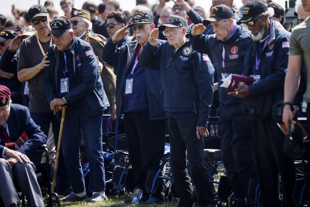 U.S war veterans salute during a ceremony outside the Pegasus Bridge memorial in Benouville, Normandy, Monday, June 5, 2023. (Thomas Padilla/AP)